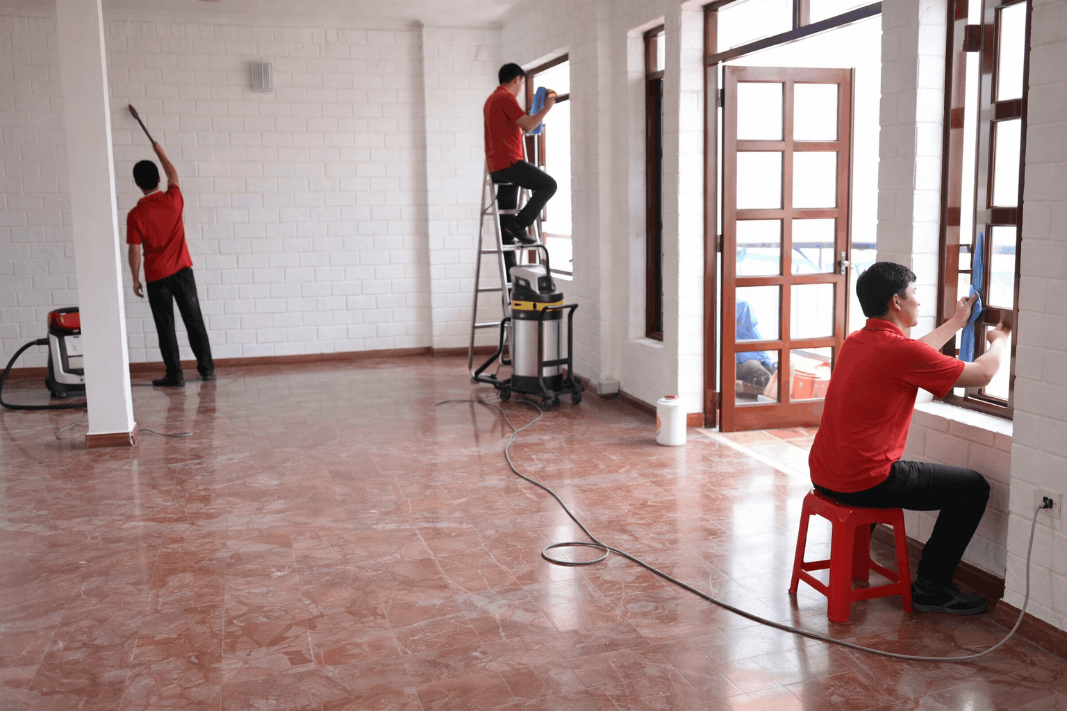Nhân viên vệ sinh sau xây dựng MCX Clean đang lau kính và làm sạch không gian nhà ở